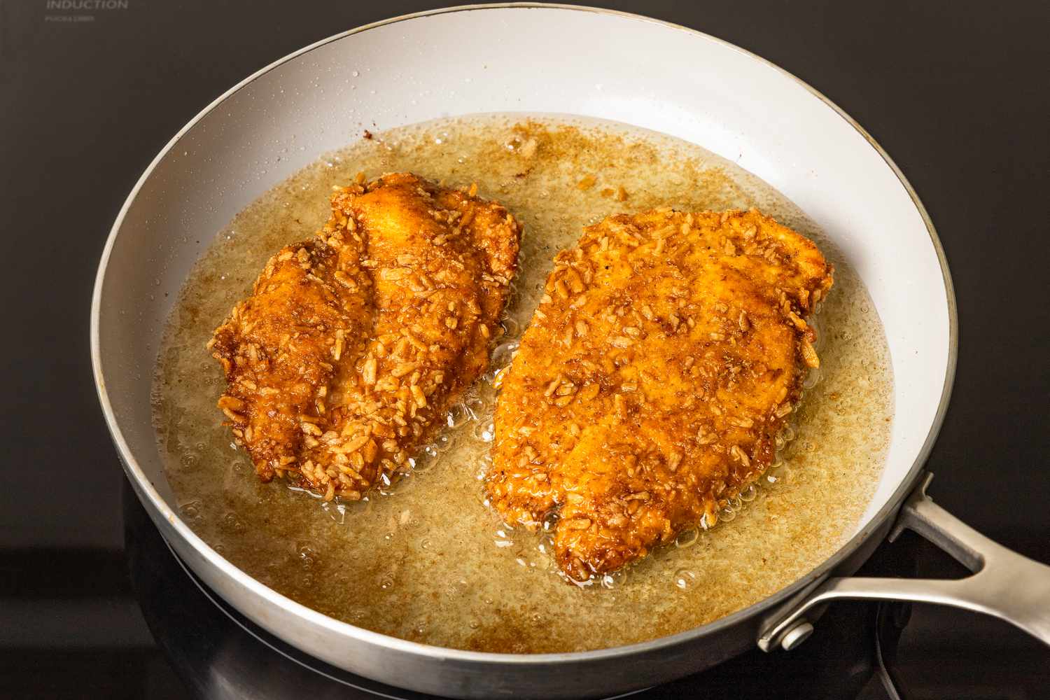 pretzel chicken flipped and fried in the pan