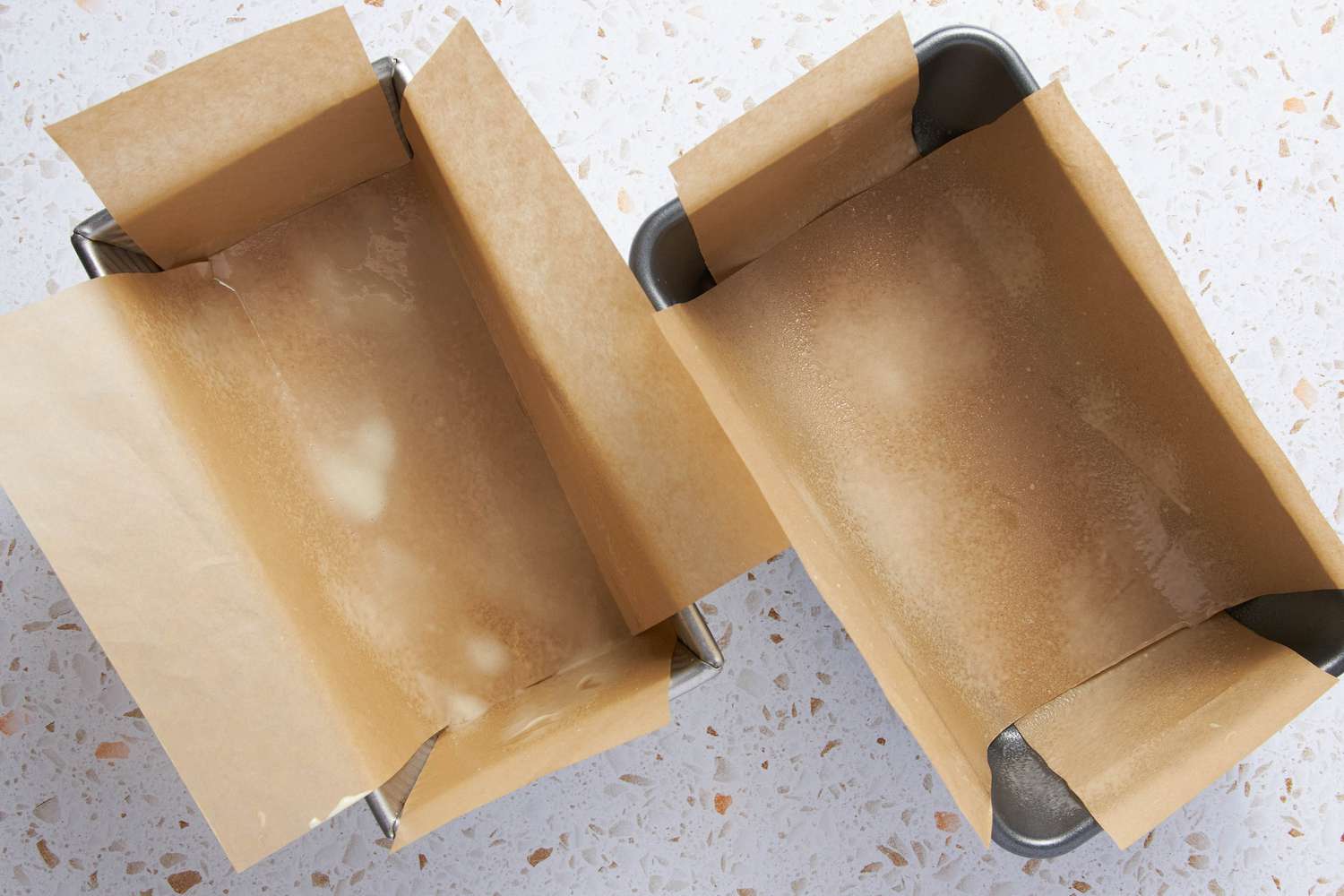 Two Loaf Pans Lined With Parchment Paper and Sprayed With Cooking Spray