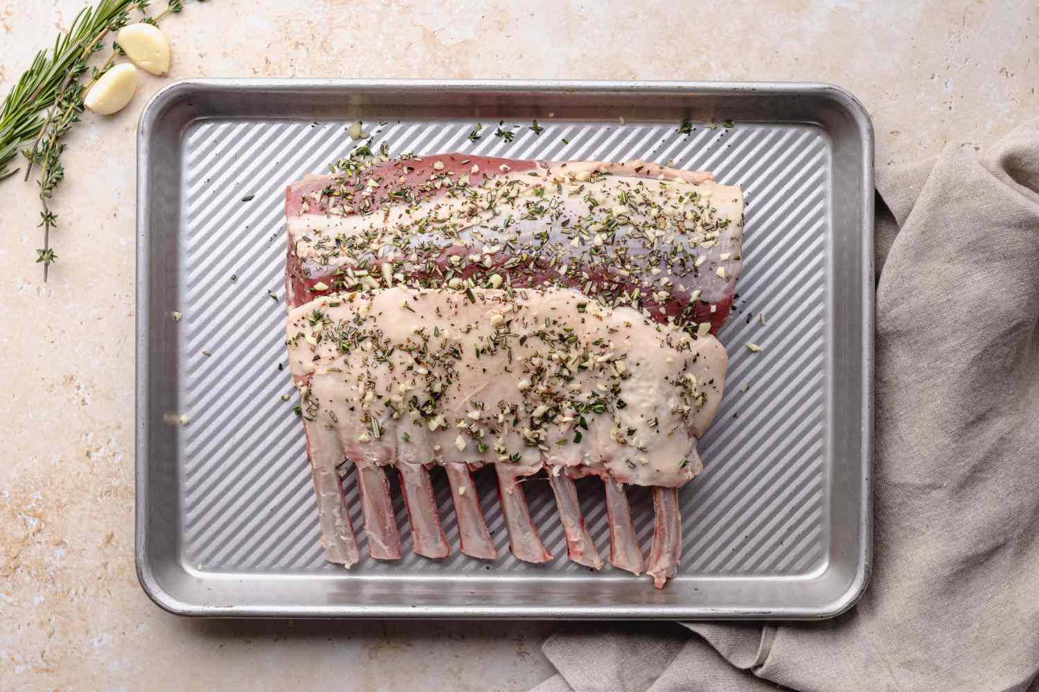Method shot - raw rack of lamb on pan