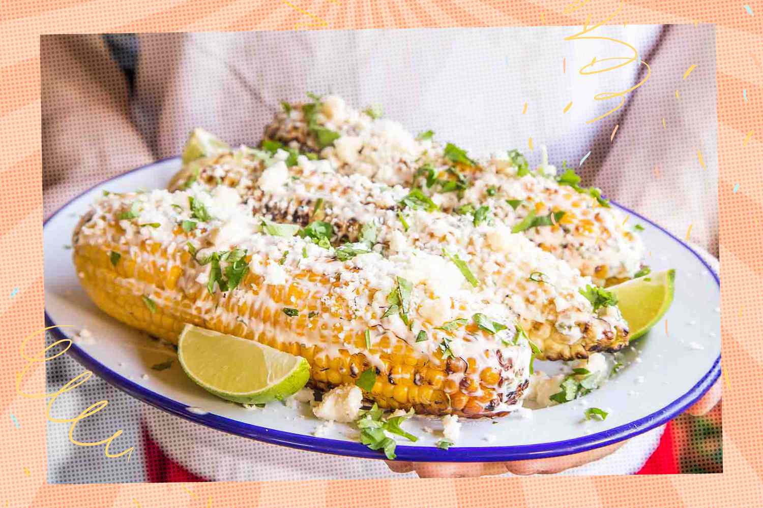 Someone holding a plate filled with elotes