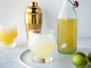 Side view of a margarita and a jar of homemade margarita mix.
