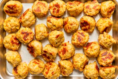 Overhead view of a metal baking sheet full of 3-ingredient chicken meatballs