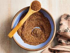 Bowl of Fajita Seasoning With Some in a Spoon Resting on the Bowl, and on the Counter, a Kitchen Towel