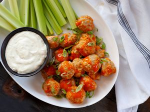 Buffalo chicken meatballs with celery and blue cheese.