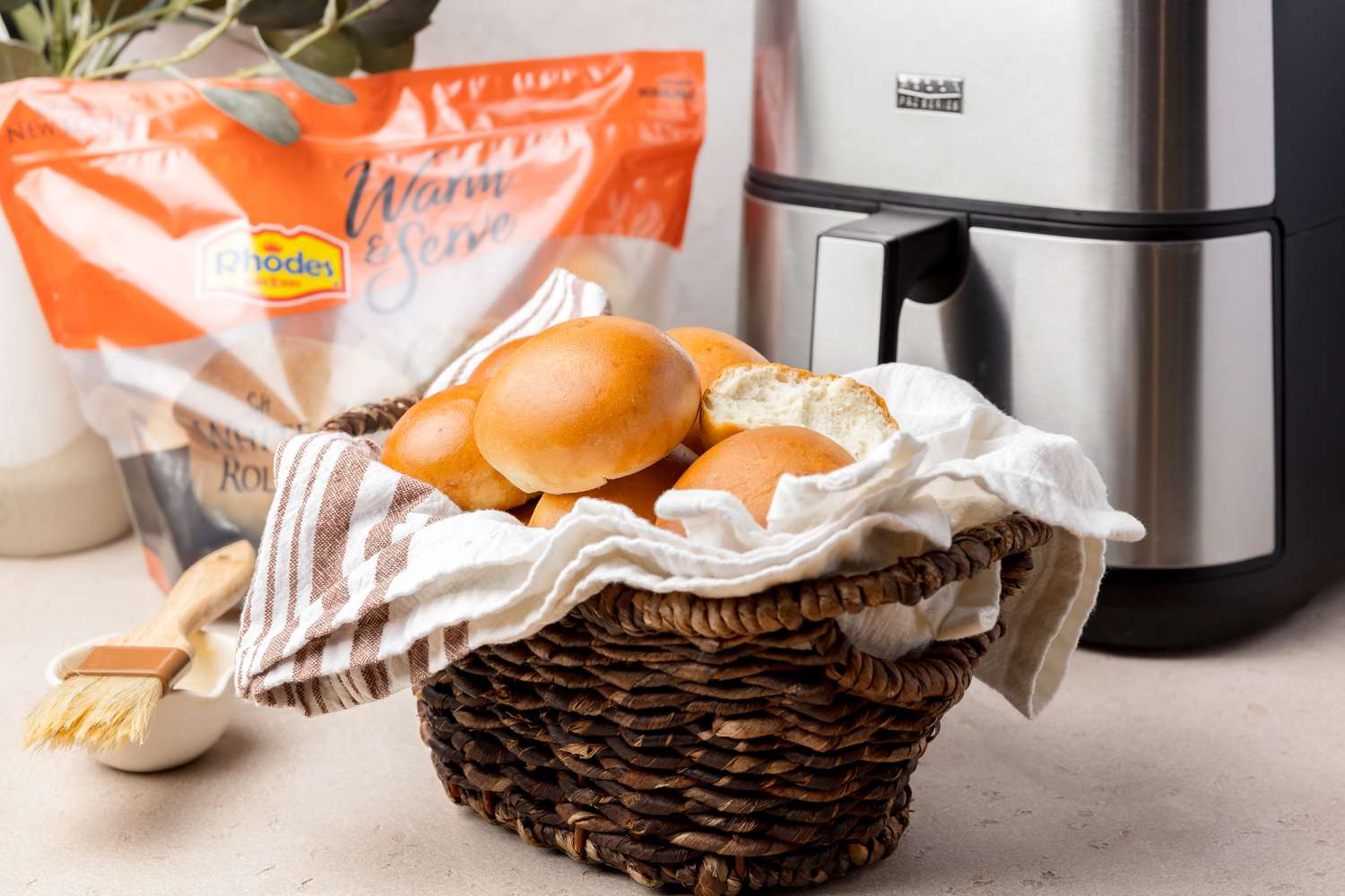 Basket of rolls in front of air fryer
