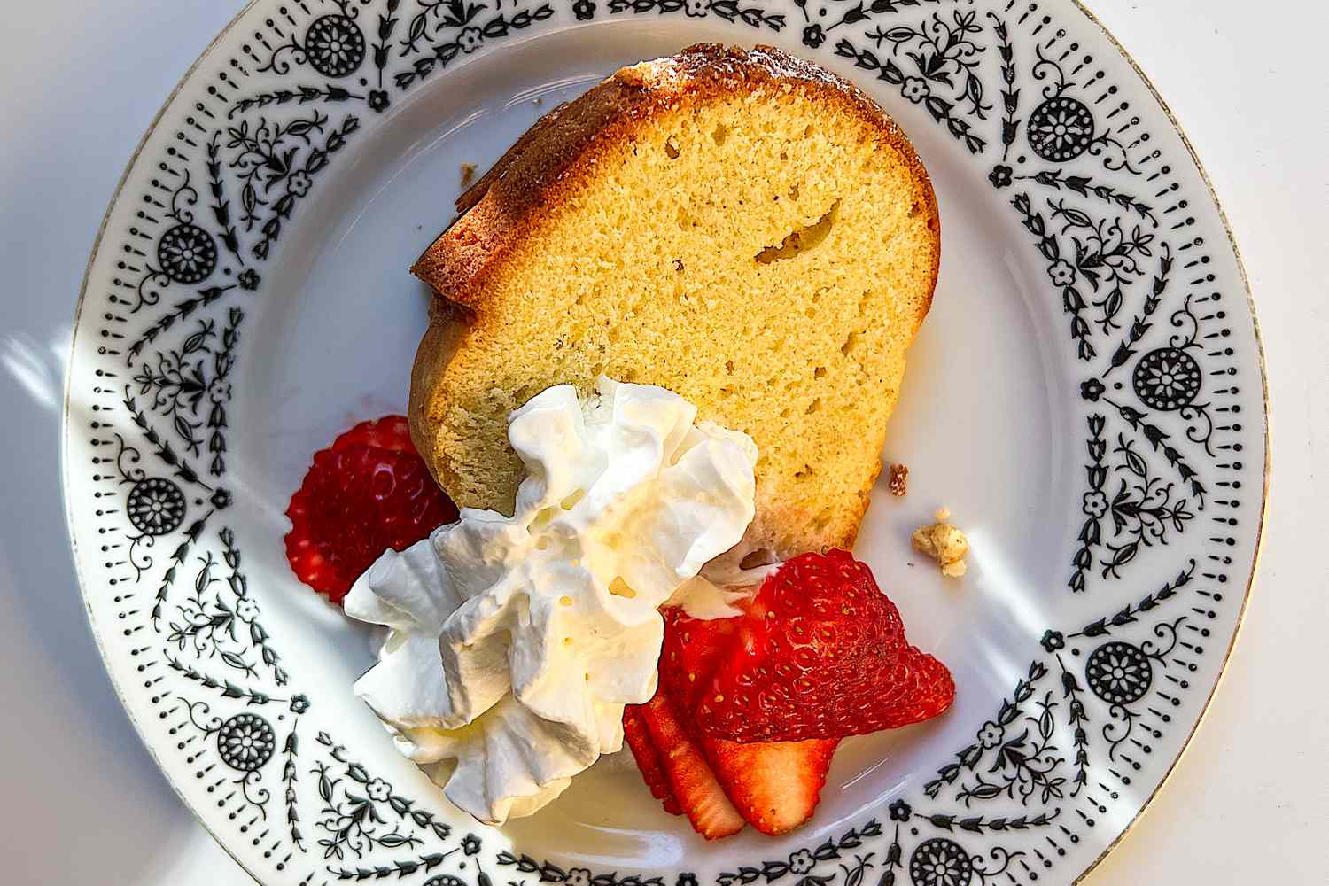 slice of reddit pound cake with whipped cream and slices of fresh berries