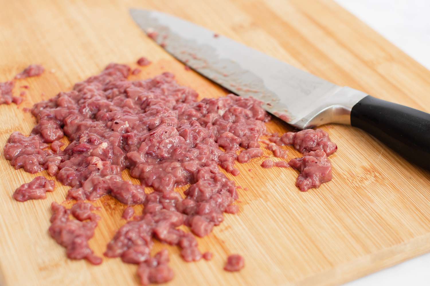 Chopping chicken livers to show how to make dirty rice.