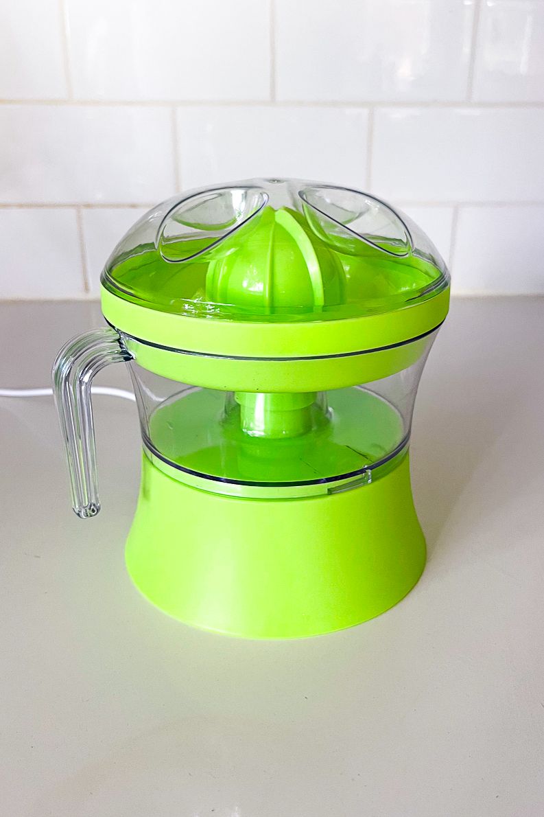 A lime green plastic citrus juicer