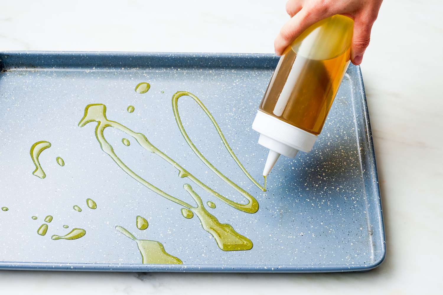 Oil Poured Onto a Sheet Pan for Sheet Pan Fried Eggs Recipe 