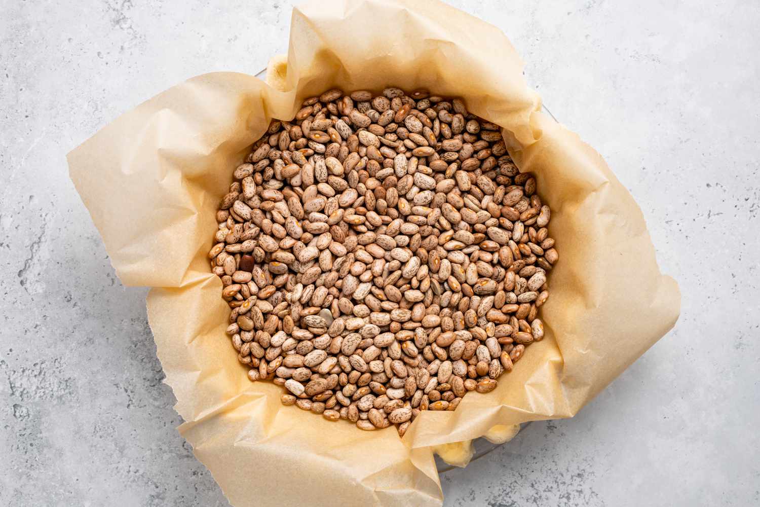 Egg Custard Pie Crust Covered in Parchment and Filled with Dry Beans 