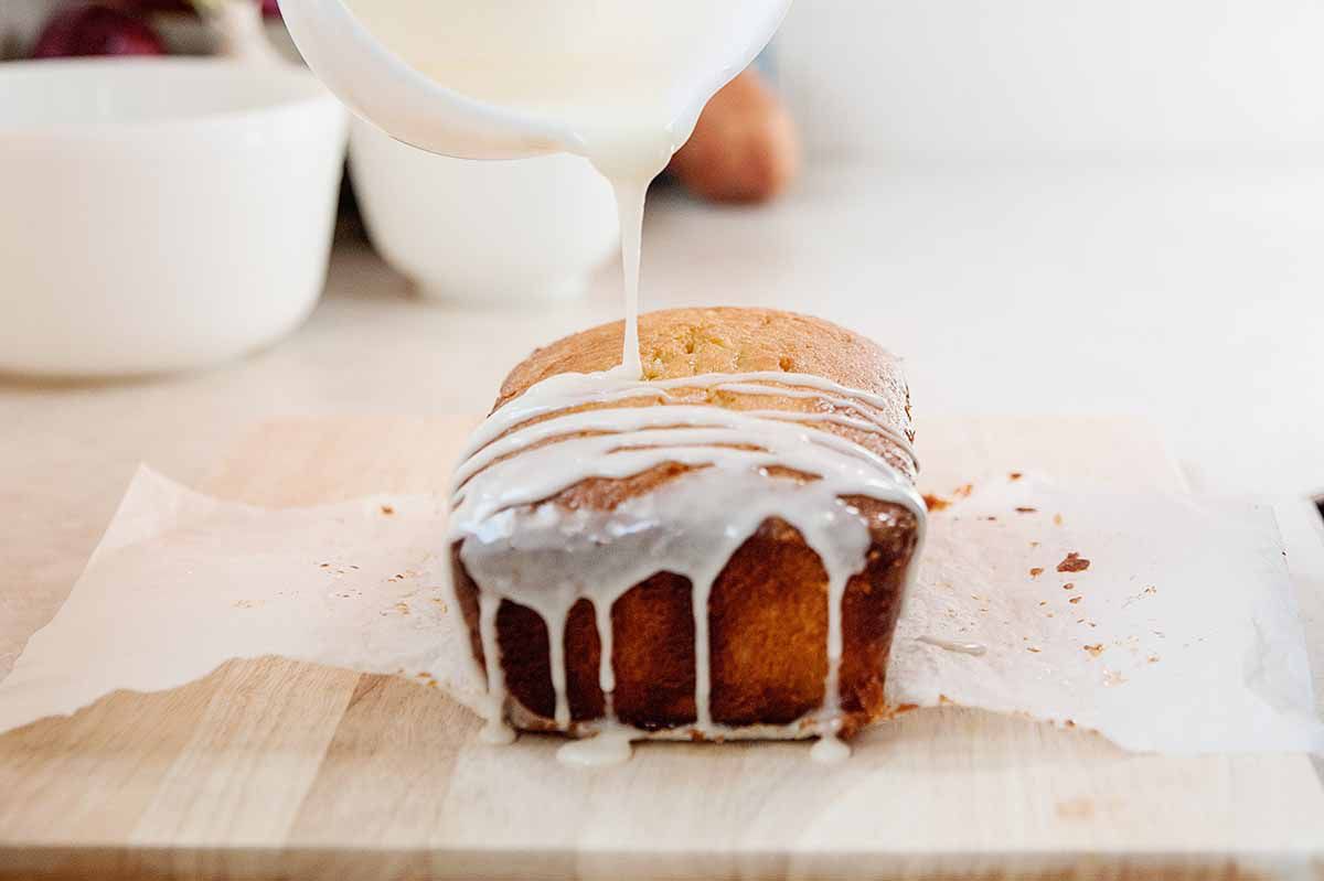 Starbucks Lemon Pound Cake Recipe - lemon icing being poured over lemon pound cake
