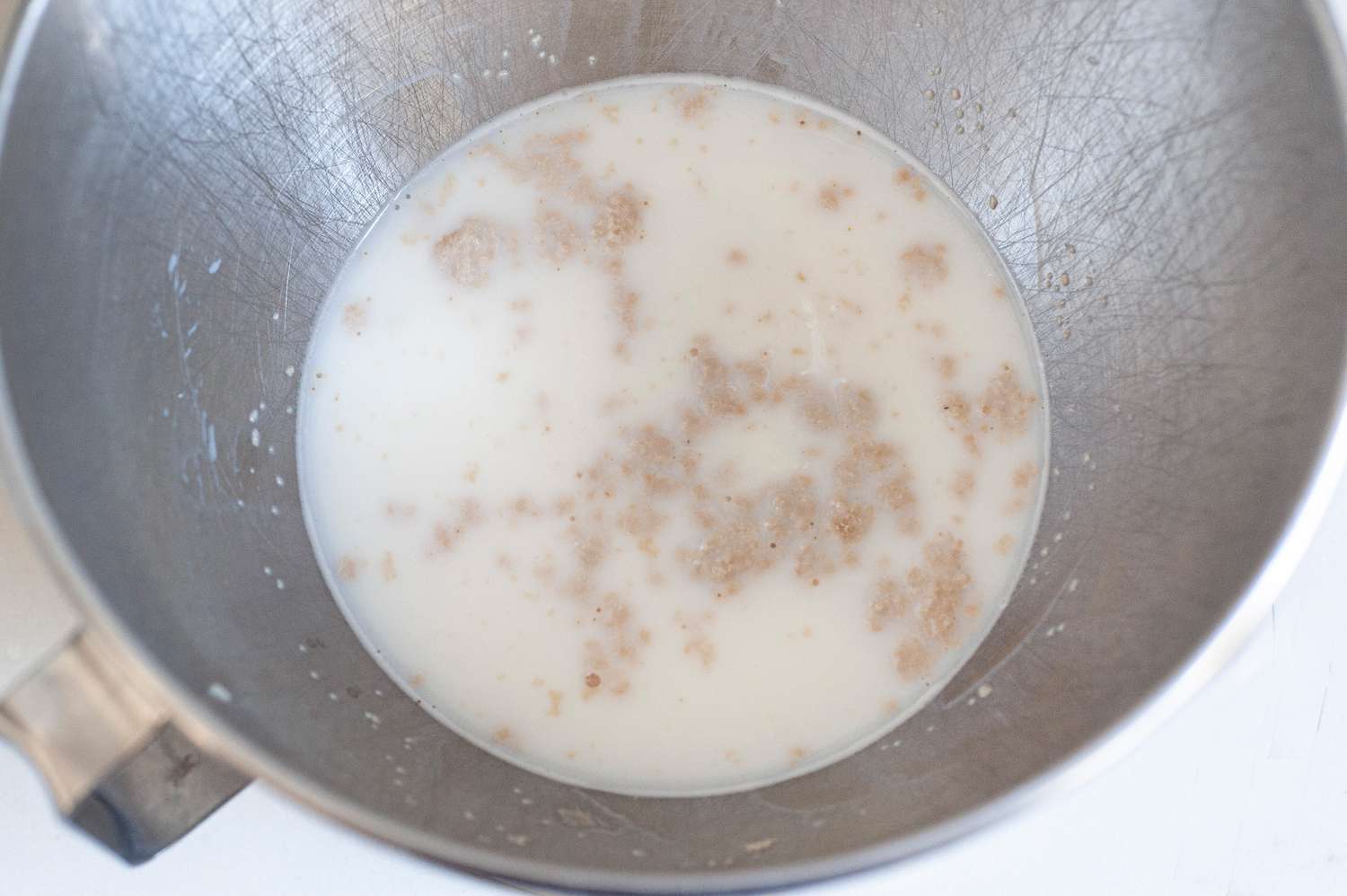 Milk and Yeast in a Mixer Bowl for Quick Dinner Rolls Recipe