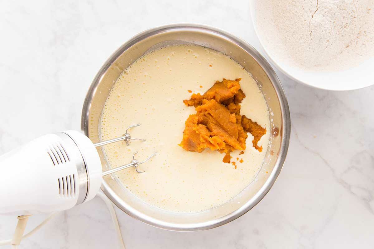 Pumpkin mixed into ingredients to make Easy Pumpkin Cake with Cream Cheese Frosting.