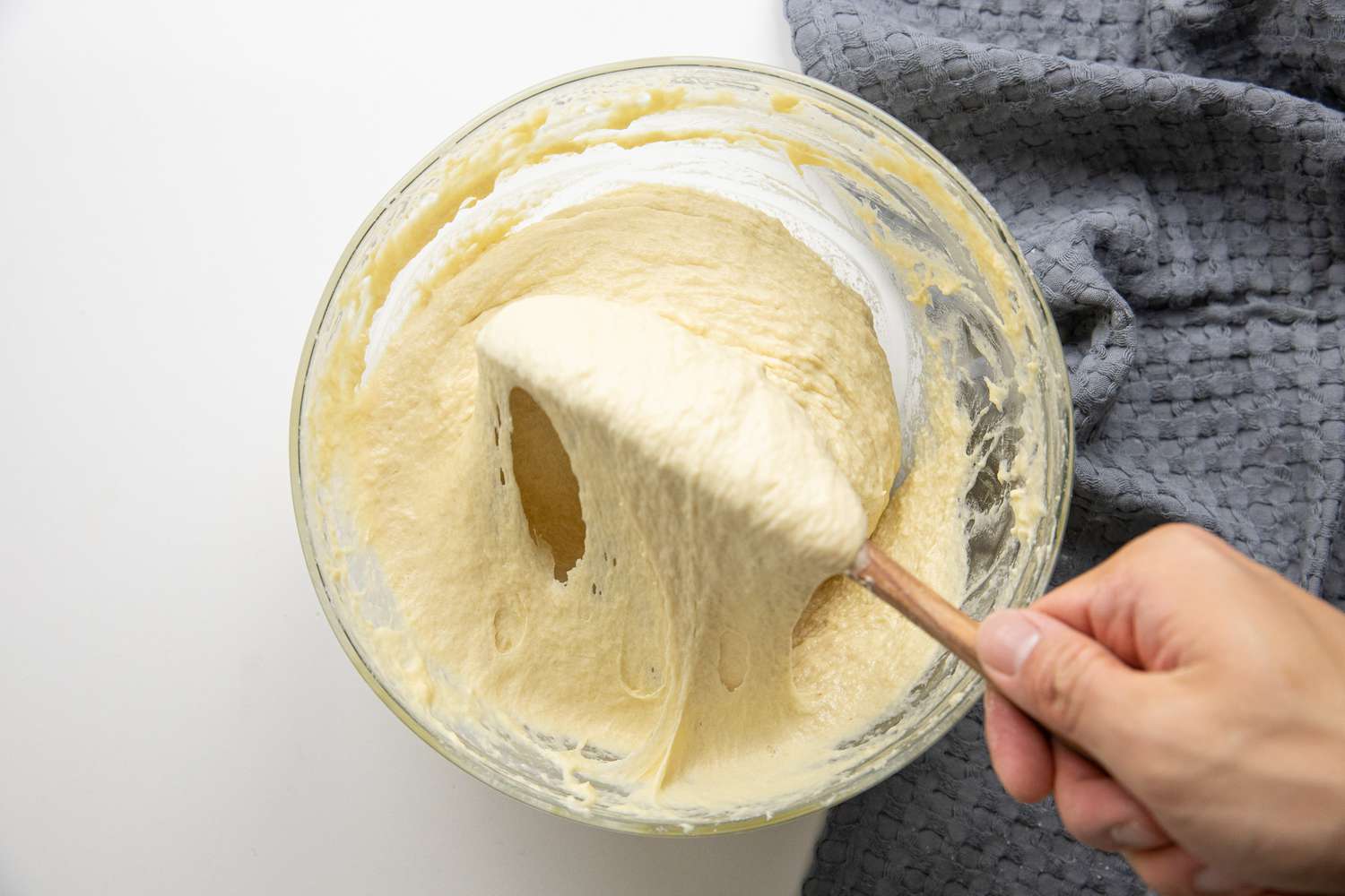 Wooden Spoon Mixing Ingredients until a Sticky Dough Is Formed for Spätzle Recipe
