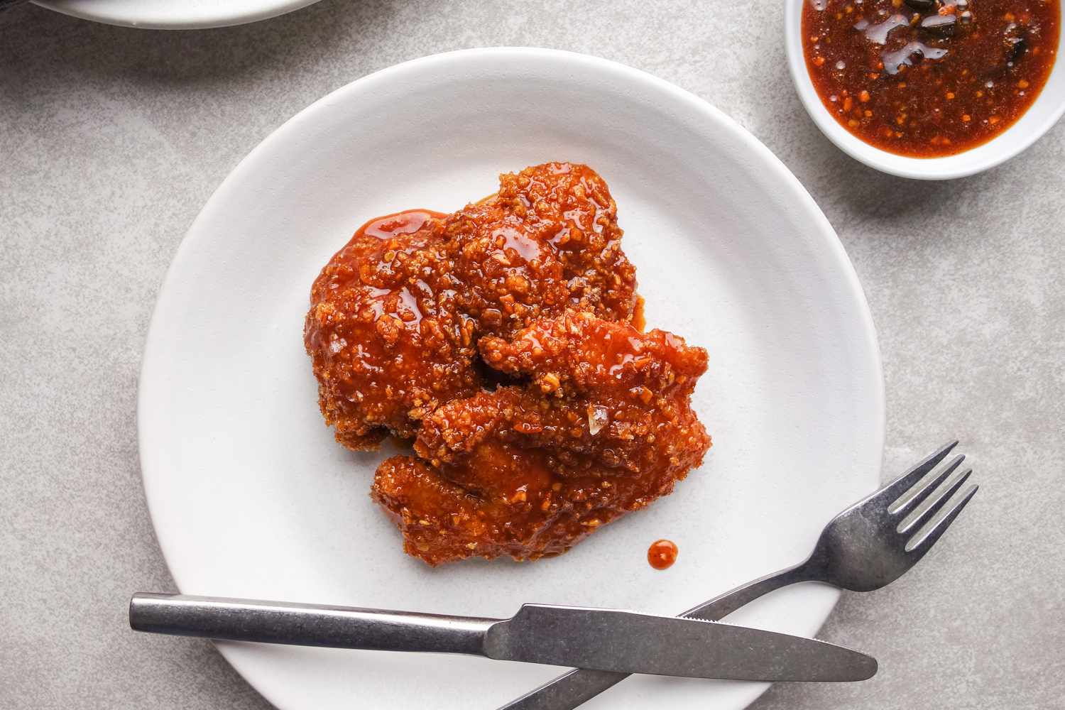 Honey honey chicken on white plate.