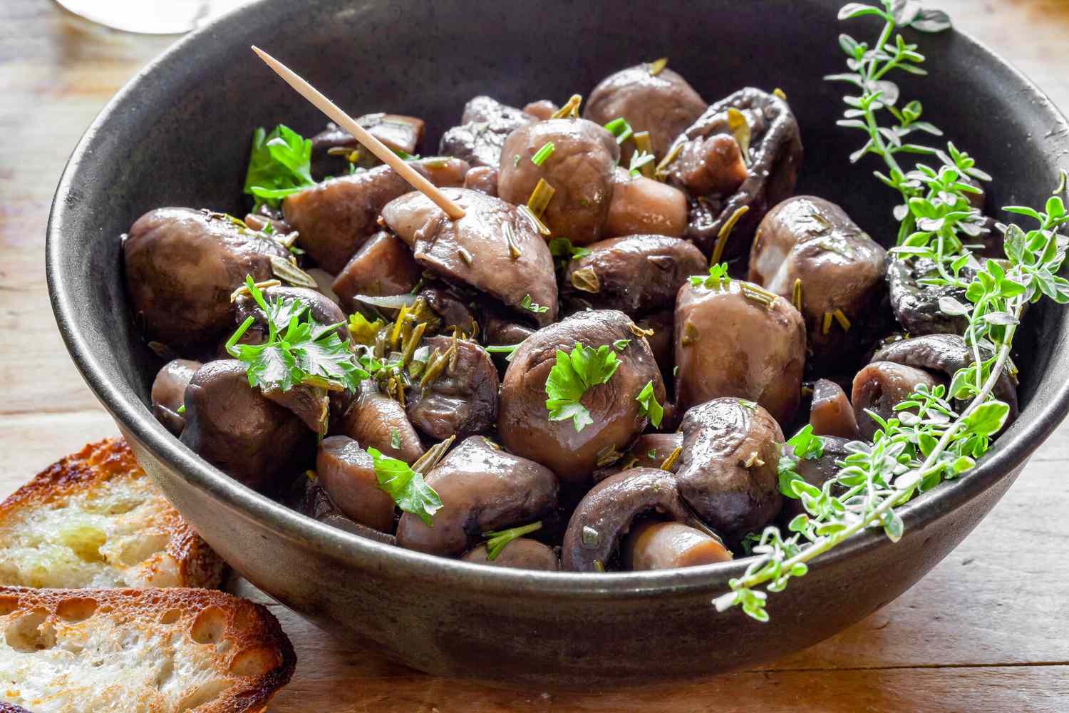 Marinated Mushrooms in a Bowl with Herbs