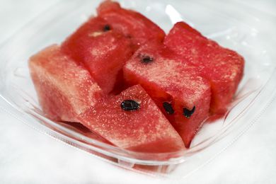 Pieces of watermelon in an open plastic to go container