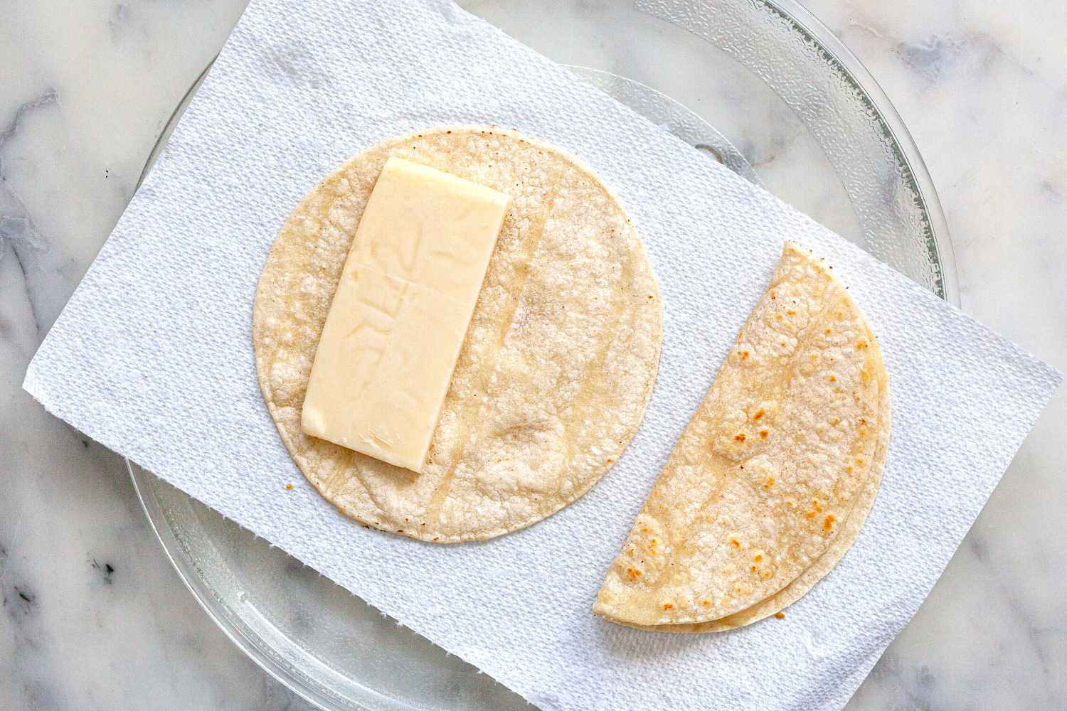 Melting cheese on a microwave platter to make a vegetarian tacos recipe.