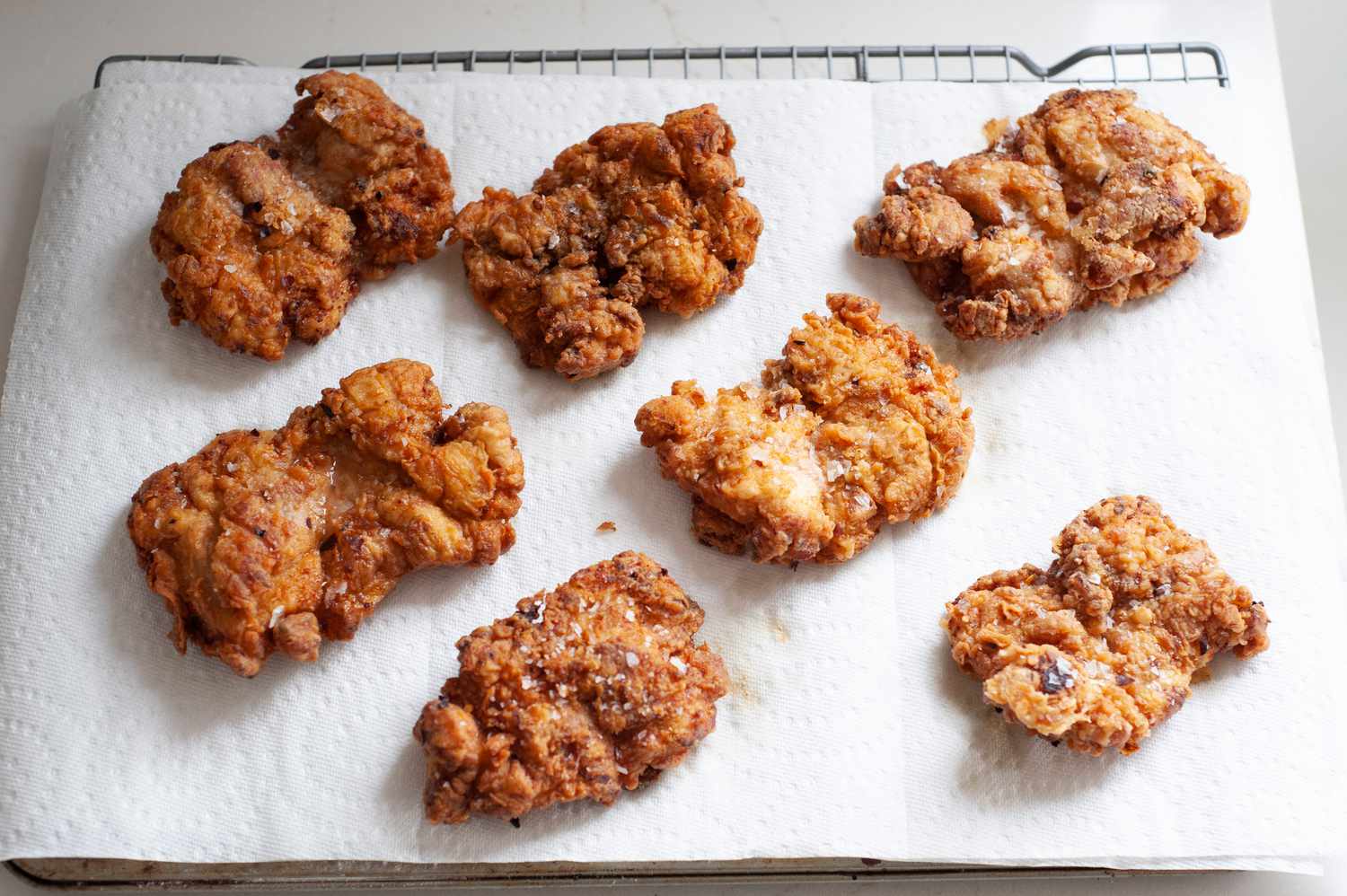 Fried chicken on paper towel on a cooling rack