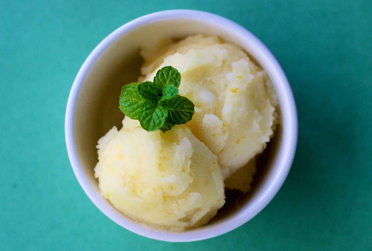 meyer lemon sorbet in a bowl with mint