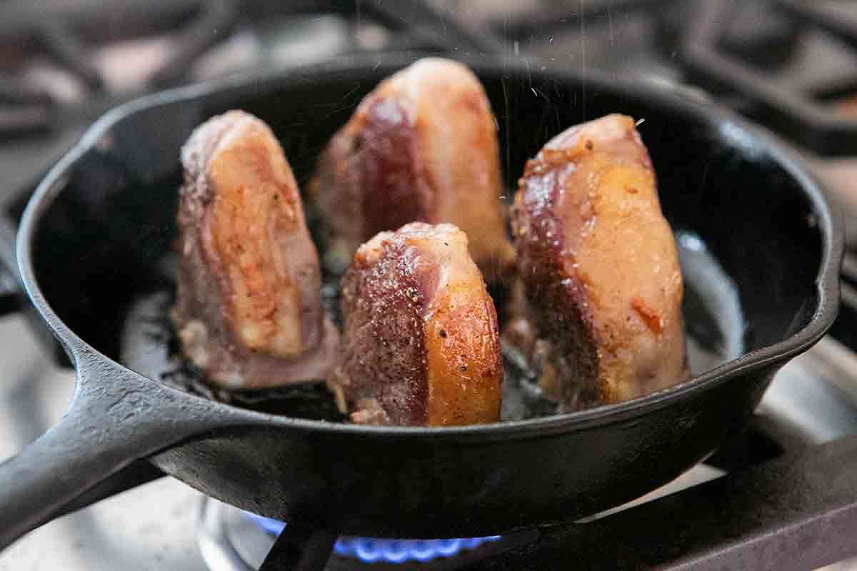brown sides of lamb chops in pan
