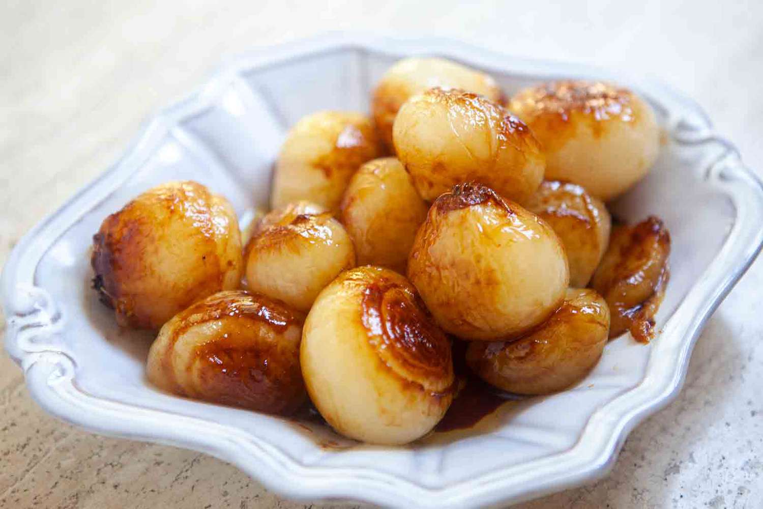 A plate with sweet and sour pearl onions on top