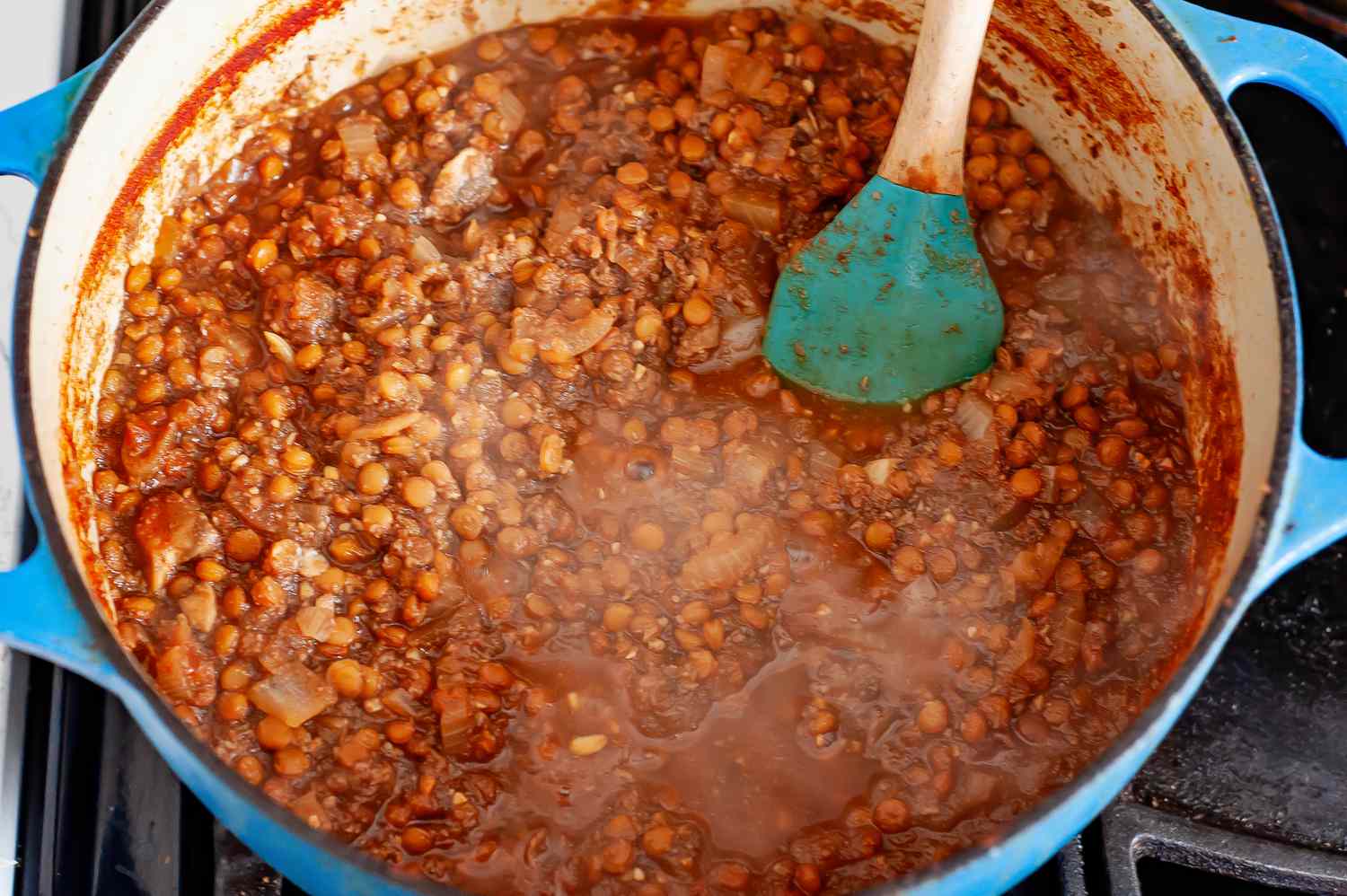 Vegan Cincinnati Chili Ingredients (Lentils, Tomato Sauce, etc.) Stirred into Dutch Oven