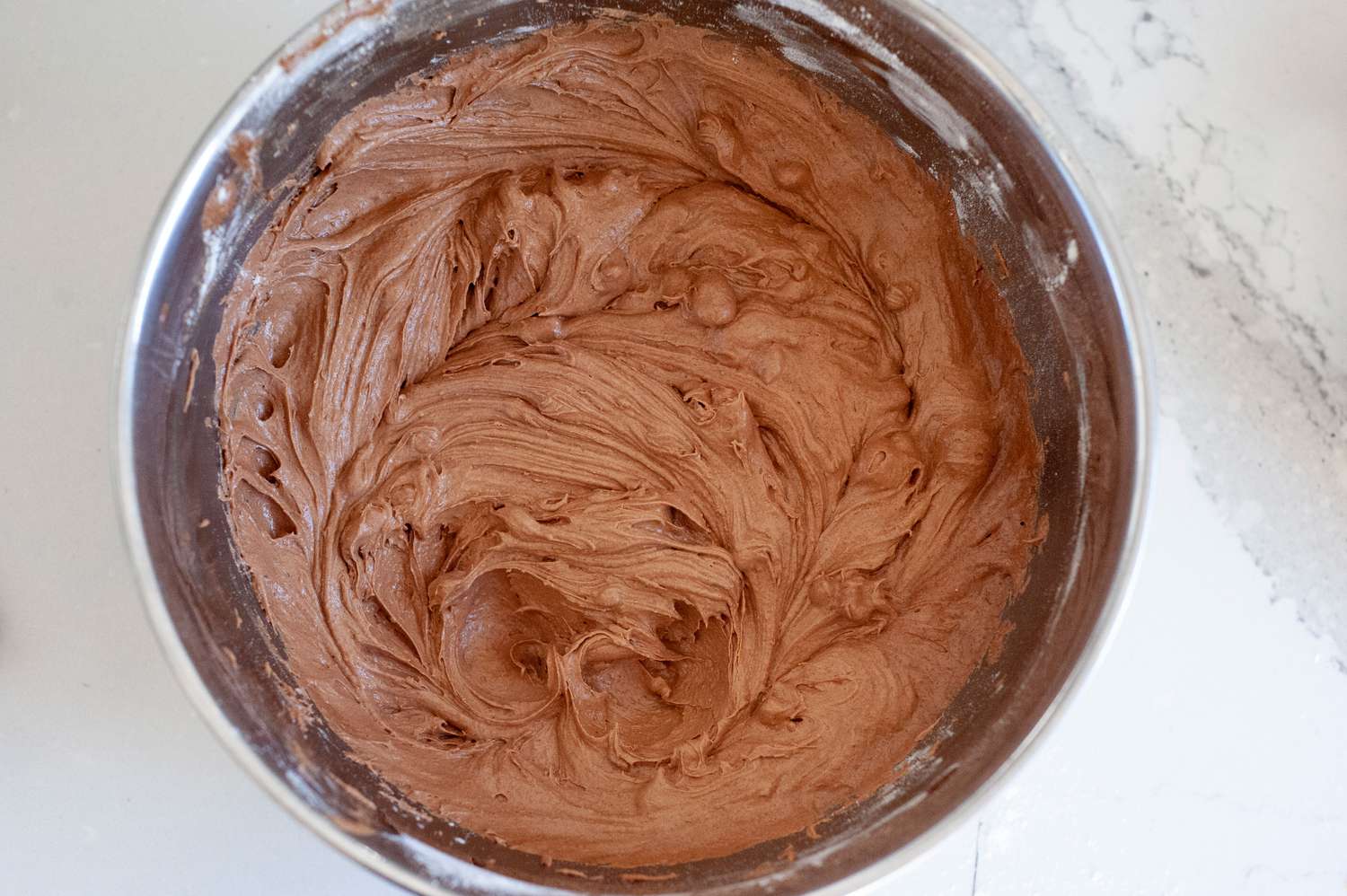 Brownie batter in a bowl with flour and nuts.