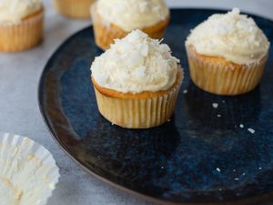 Coconut Cupcakes with Coconut Cream Cheese Frosting on a Plate