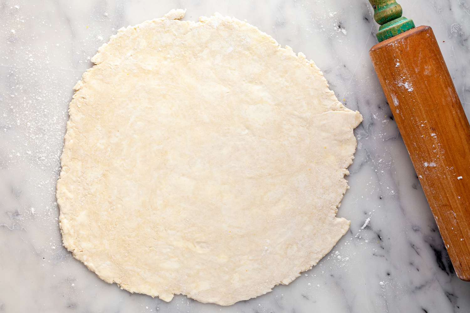 Pie Dough Rolled Out on a Counter Using a Rolling Pin for Blackberry Pie