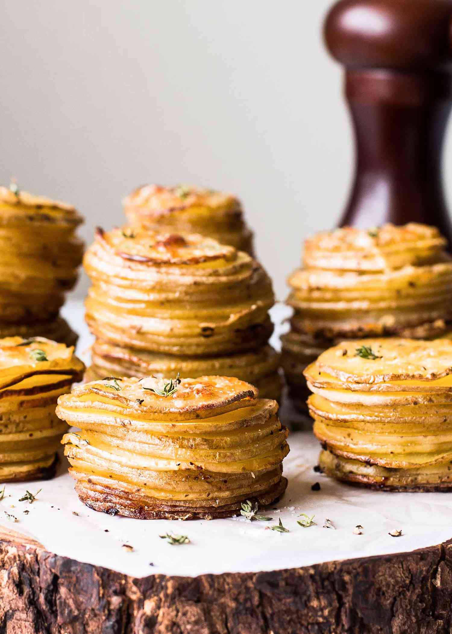 Stacked layers of cooked potato slices on wood
