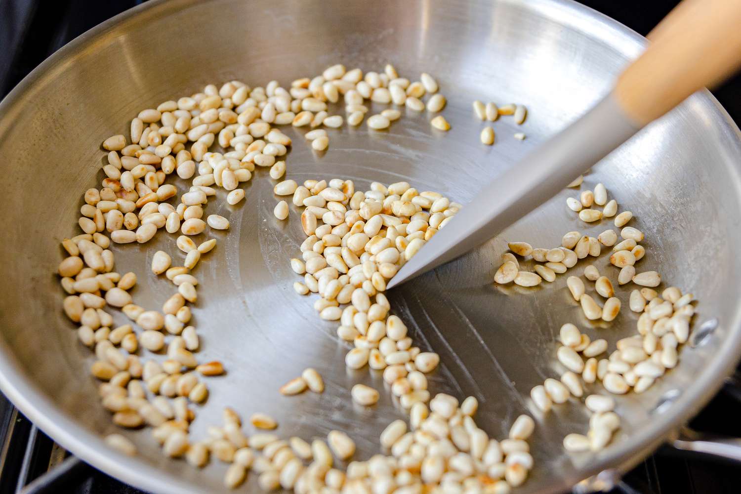 Raw Pine Nuts Being Toasted on a Skillet