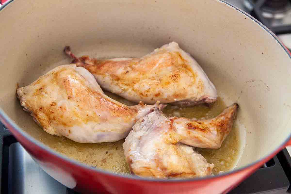 brown rabbit parts in dutch oven