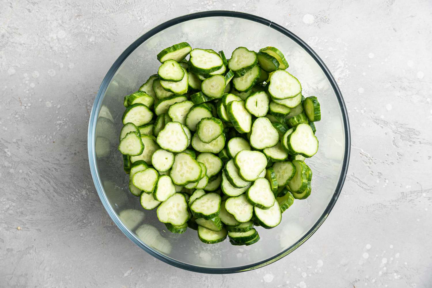 A bowl filled with sliced cucumbers