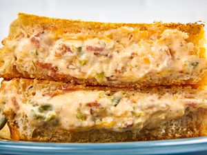 Cross-section of jalapeÃ±o popper grilled cheese (two sandwich halves) stacked on a plate