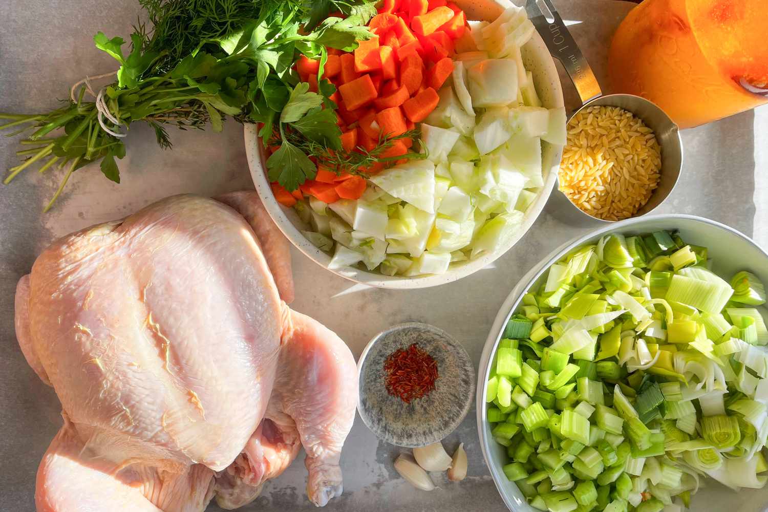 Ingredients laid out on a counter for Ina's Chicken in a Pot recipe
