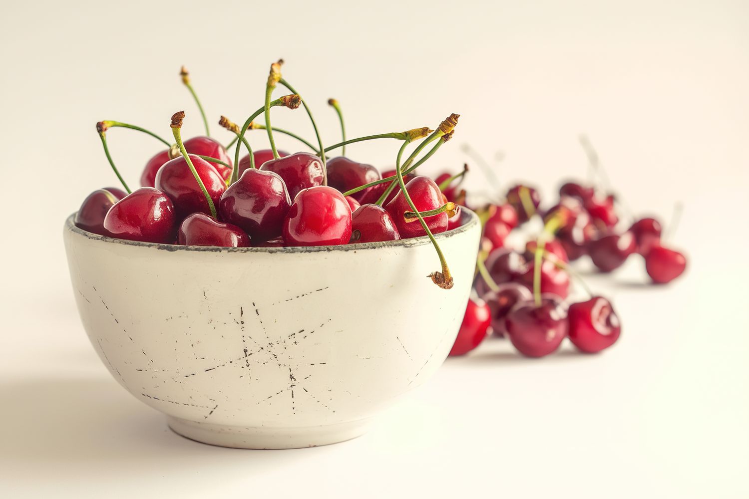 Bowl full of cherries isolated on white background