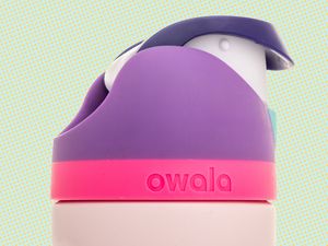 A bottle of Owala leak proof built in straw tumbler on an isolated background.