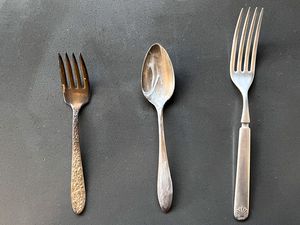 From L to R: a Tarnished Silver Fork, a Spoon With Toothpaste, and a Polished Fork on the Counter for How to Clean Silver
