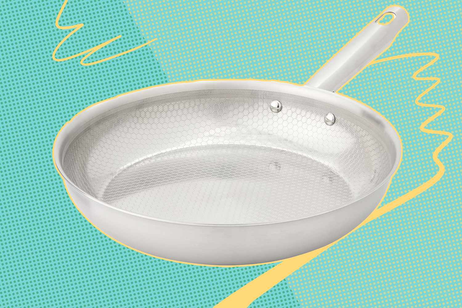A stainless steel frying pan with a textured interior against a patterned background