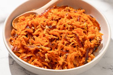 Shredded Carrot Salad in a large bowl with a wooden spoon