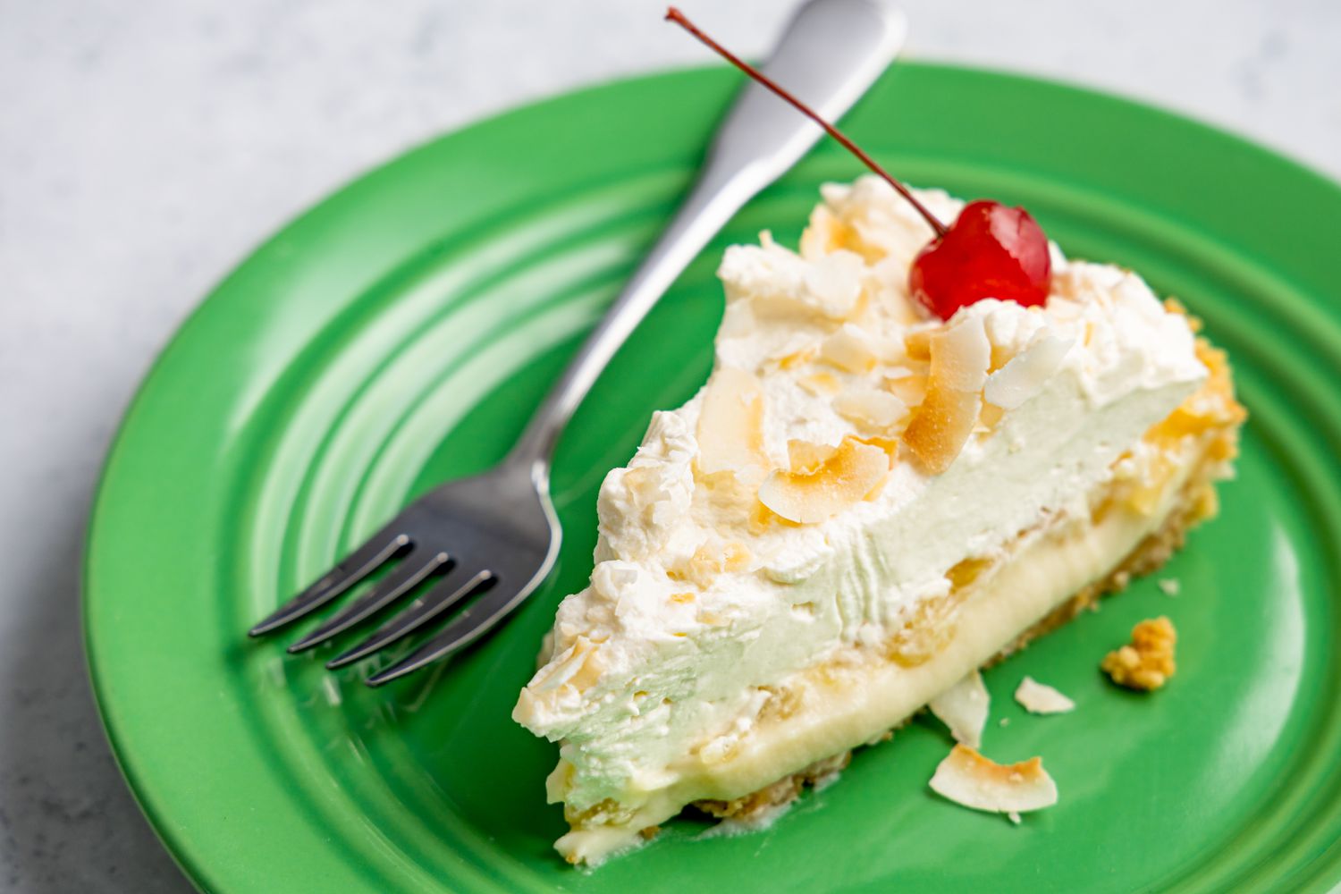 Slice of Piña Colada Pie on a Plate with Some on a Fork