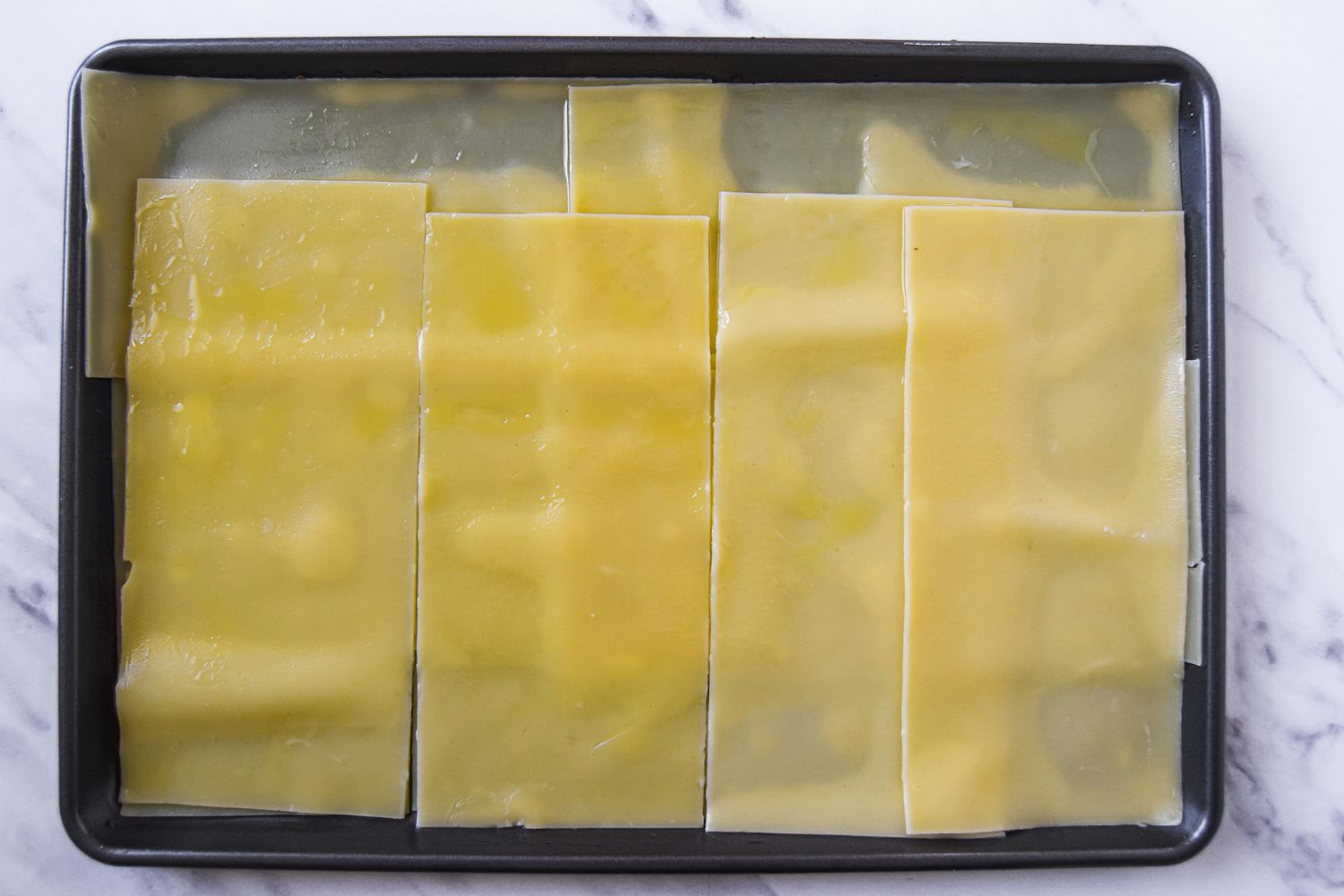 Lasagna Noodles on laid flat on a Baking Tray