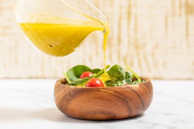 3-minute lemon dressing poured onto a small bowl of salad