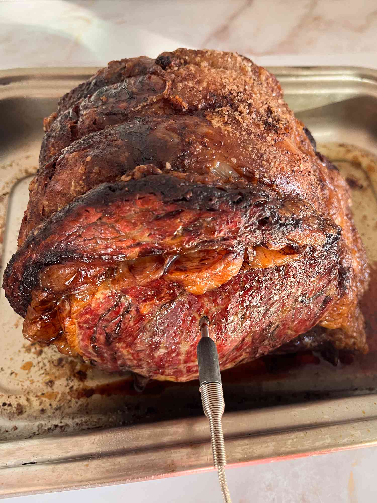 Thermometer inserted into a rack of prime rib