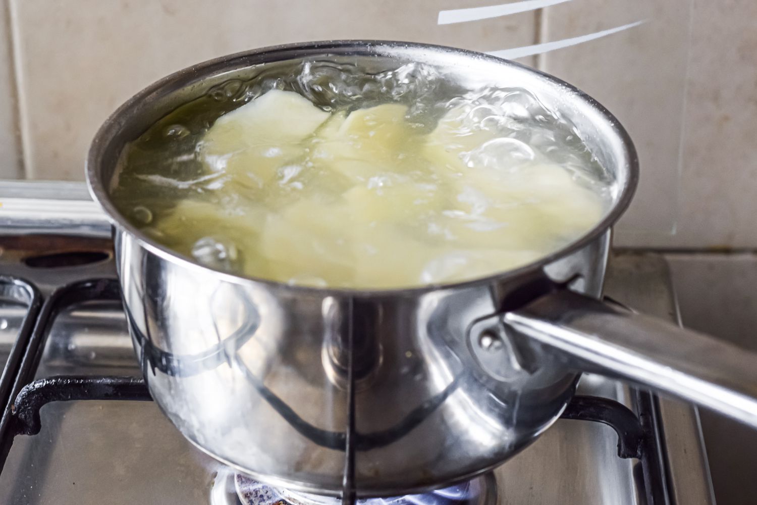 Pot of Boiling Water and Potatoes on a Stove for Mashed Potato Recipe