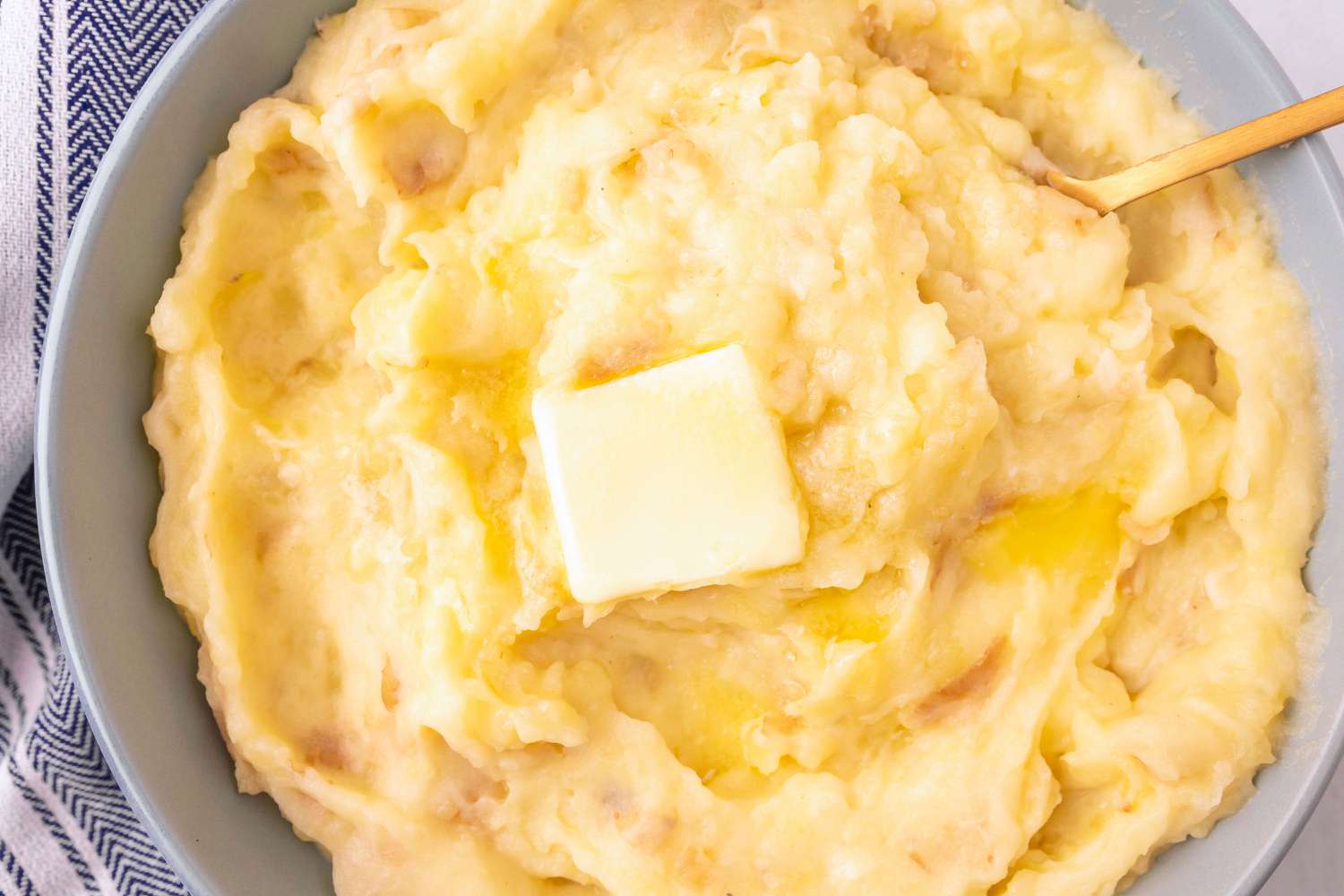 3-Ingredient Garlic Mashed Potatoes in a bowl topped with a pat of butter