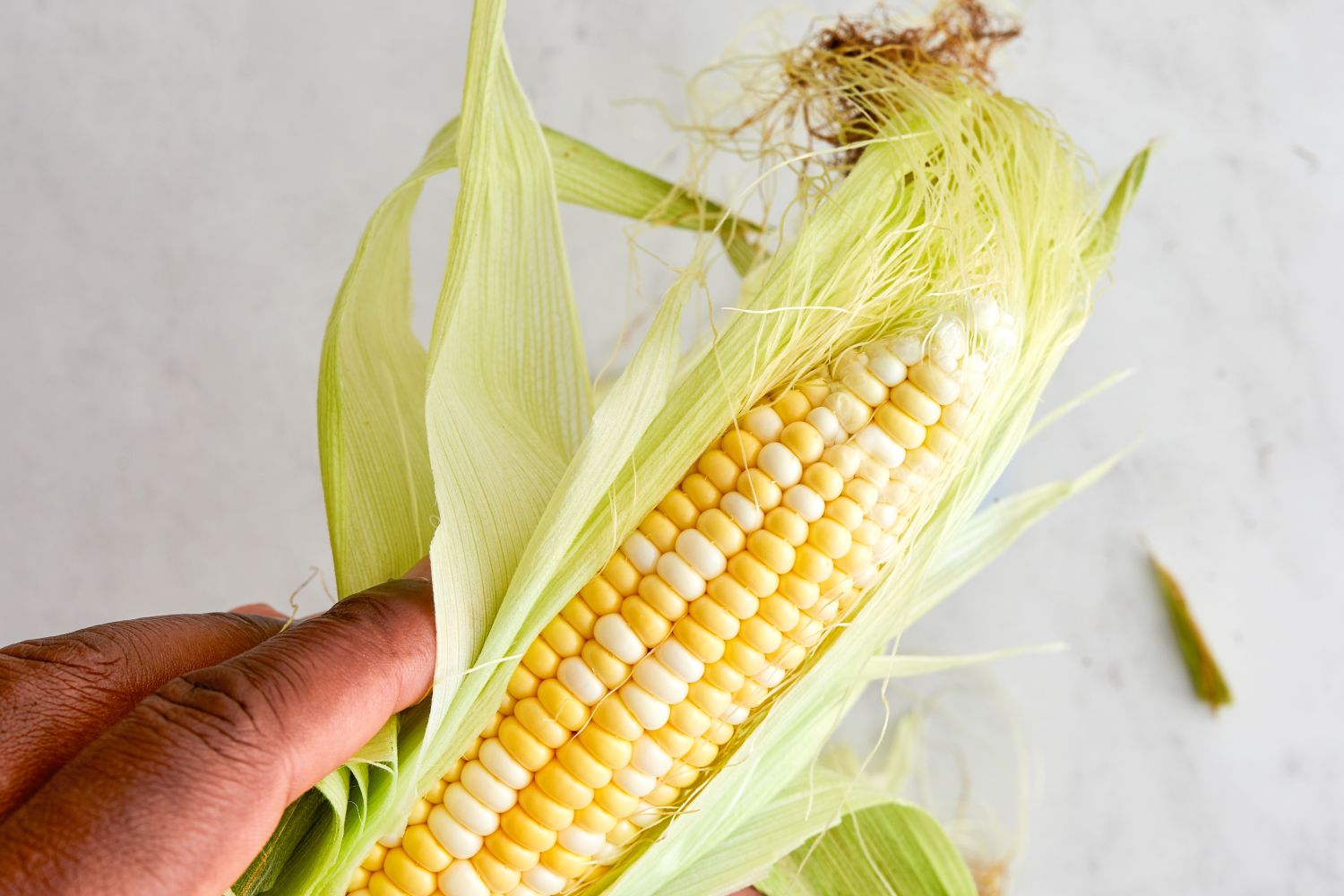 Hand Husking Corn for Cajun Corn Recipe
