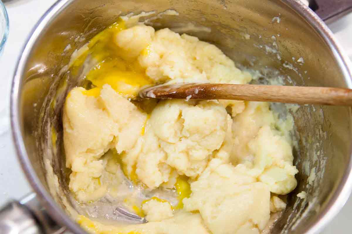 add eggs one at a time to cheese puff gougere dough