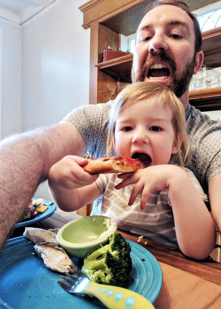 Child eating homemade pepperoni pizza
